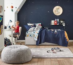 a child's bedroom with space themed decor