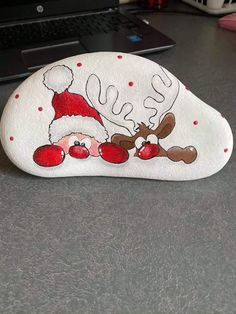 a hand painted rock sitting on top of a desk