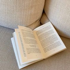 an open book sitting on top of a couch