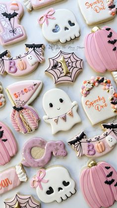 some decorated cookies are laying on a white table top with halloween decorations and words written on them