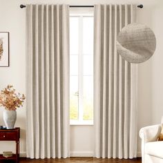 a living room with white curtains and wooden floors