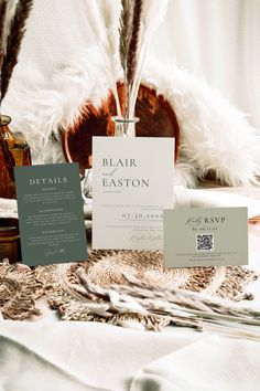 the table is set up with feathers and cards for guests to write their own names