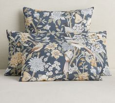 two pillows with birds and flowers on them