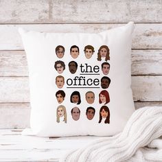 a pillow with the faces of people on it that says, the office in black