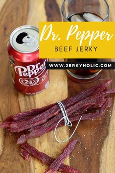 Dr. Pepper Beef Jerky tied in a bunch on a wooden board with a can and glass of Dr. Pepper in the background. Honey Garlic Beef Jerky, Deer Jerkey Marinades, Beef Jerky On Smoker, Dr Pepper Jalapeno Beef Jerky, Dehydrator Spices, Beef Jerky Seasoning Recipes, Dr Pepper Jerky Recipe, Beef Jerkey Marinades Dehydrator, Ground Beef Jerky Recipes Dehydrator