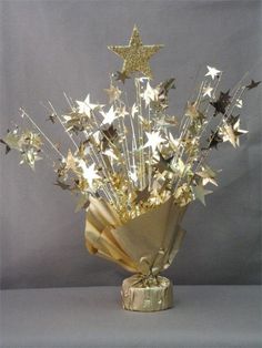 a vase filled with lots of stars on top of a table