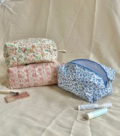 Multifunctional handmade quilted pouches, perfect for makeup, school supplies, toiletries, travel essentials, skin care, etc. Super cute and aesthetic for organization. They make the perfect gift for someone!  🌷Measurements In Inches: Blue Floral- 8 long x 4 wide x 4 tall  Pink Floral- 8 long x 4 wide x 4 tall  Orange Floral-  7 1/2 long x 5 wide x 4 tall  🌷Care Instructions: Machine washable on delicate or handwash.  Air dry (don't put it in the dryer) Perfect gift for Mother's Day, wedding, Floral Makeup Pouch, Makeup Bags Cute, Makeup Bags Aesthetic, Floral Print Aesthetic, Quilted Pouches, Makeup Bag Aesthetic, Quilted Makeup Bag, Floral Makeup Bag, Xmas Wishlist