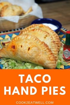 taco hand pies with lettuce and tomato sauce on the side for dipping