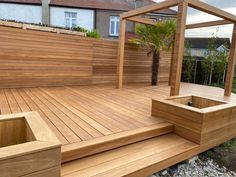 a wooden deck with steps and planter boxes