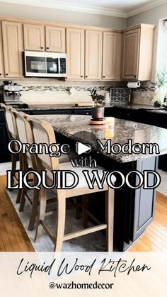 an orange modern kitchen with liquid wood in the center and black appliances on the other side