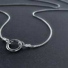 Stylish and versatile, this sterling silver box chain necklace boasts a front circle clasp, ideal for interchangeable charms and pendants. Details Chain: Sterling Silver rounded box chain, 1.8mm Clasp: Sterling Silver hinged circle push clasp, 14.5mm Sizes: 16 inches to 36 inches Shipping: Ready to ship within one business day Complimentary shipping in the USA Complimentary gift wrap Box Chain Necklace, Personalized Gift Wrap, Silver Chain Style, Round Box, Silver Box, Box Chain, Snake Chain, Chain Styles, Solid 925 Sterling Silver