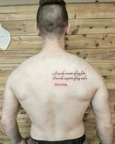 a man with his back turned to the camera has a quote tattooed on his chest