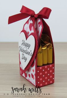 a valentine's day card in a box with hearts on it and candles inside