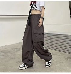 get the perfect balance of style and comfort with these emo straight wide leg drawstring cargo pants. featuring an oversized fit and a drawstring waist for extra comfort and a tailored look. Streetwear Straight Cargo Pants With Drawstring, Streetwear Cargo Pants With Drawstring, Trendy Baggy Parachute Pants With Multiple Pockets, Trendy Oversized Wide Leg Pants With Pockets, Baggy Drawstring Cargo Pants For Streetwear, Baggy Cargo Pants With Drawstring For Streetwear, Baggy Techwear Cargo Pants With Drawstring, Trendy Oversized Pants With Side Pockets, Wide Leg Streetwear Pants With Drawstring