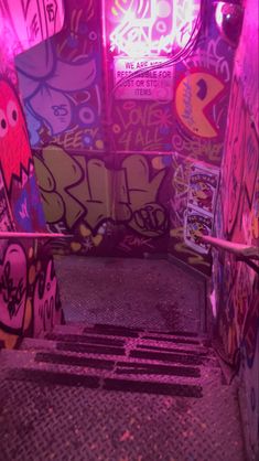 graffiti is painted on the walls and floor in an area with metal grate steps