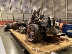 an old car is being worked on in a museum