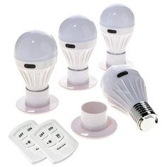 four white light bulbs sitting on top of each other next to a cup and saucer