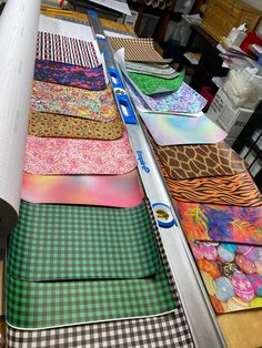 many different patterns and colors are on the conveyor belt in this shop, along with other fabrics