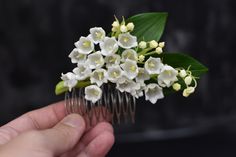 Lilies of the valley flowers hair pin are perfect spring-summer accessory for wedding or party look. Pretty, romantic, softly. All of my items are designed and carefully handmade by me. Size :  The length of the branches of lilies of the valley 3.54 inches (9 cm );  the width of the branches of lilies of the valley 1.57  inches (4 cm); Metal comb base. Material: air dry flower clay (cold porcelain). It is a hypoallergenic material. Every work is unique: all plant details are made, painted and connected by hand.  The flowers are soft and tender.  A few notes to remember: * Accessories and jewelry with flowers hould be handled with care and dry cleaning with the brush feather pen, no lasting contacts with water (like swimming or bathing). If the flower has got a small amount of water all you