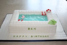 a birthday cake with a hot tub and flamingos in the pool on it that says ben happy birthday