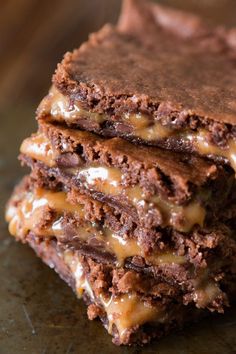 three chocolate brownies stacked on top of each other with caramel drizzle