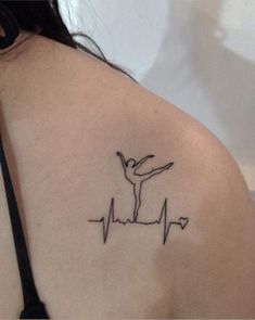 a woman's shoulder with a heartbeat tattoo on it