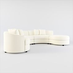 a large white sectional couch with pillows on it's back and side facings