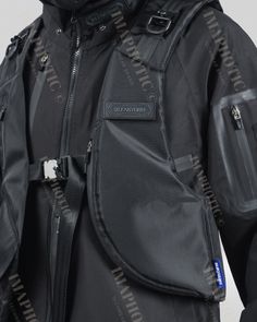 the back of a black jacket with zippers on it and an attached belt around the waist