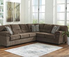 a living room with a sectional couch and rug