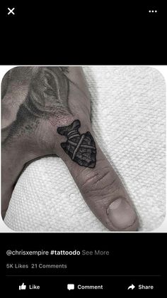 a person's hand with a tattoo on it