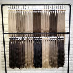 there is a rack that has different colored hair on it and two rows of them