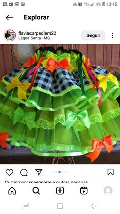 a green skirt with orange and yellow bows on the bottom is displayed in an instagramtion