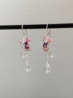 This pair of elegant shimmering sterling silver (925) drop earrings have been intricately crafted with beads hand wrapped onto silver and mounted like a cascade on a small silver chain. The stones are as follows: 2 faceted drops of rose quartz (size approx. 5 x 9 mm), 3 buttons each made of rhodochrosite (size 3 x 6 mm), 3 faceted beads made of rock crystal (diameter approx. 4 mm), 2 dice each of dark red, luminous ruby and 1 faceted button made of rhodochrosite (size approx. 3 x 4 mm). The earrings have a length of 5.5 cm. The ear hooks are 1.5 cm long, the pendants 4 cm. All silver parts used are sterling silver. The stones used as healing stones are also said to have a certain effect: Rose Quartz is the stone for the heart - it represents compassion, love, unconditional love, self-love Sterling Silver Gemstone Beads Dangle Earrings, Sterling Silver Dangle Earrings With Gemstone Beads, Sterling Silver Gemstone Beads Earrings, Gift, Silver Teardrop Chandelier Earrings With Natural Stones, Silver Sterling Chandelier Earrings With Natural Stones, Silver Faceted Dangle Crystal Earrings, Silver Dangle Earrings With Gemstone Beads, Rose Quartz Gemstone Dangle Earrings, Elegant Sterling Silver Crystal Earrings With Dangling Beads