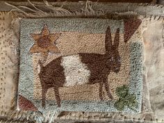 a patchwork pillow with an image of a cow and star on it's side