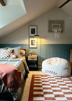 a bedroom with a bed, rug and basketball hoop on the wall in it's corner