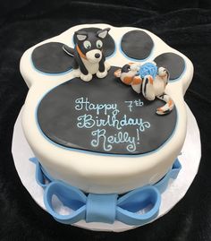 a birthday cake with an image of a cat and dog on it's side