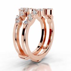 two rose gold wedding rings with diamonds on each side and the center diamond in between them