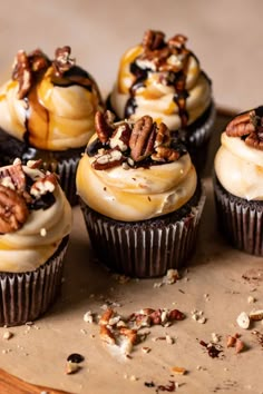 several cupcakes with pecans and nuts on top