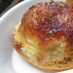 two small pastries sitting on top of a white plate