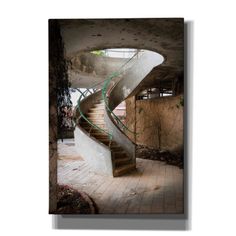 a spiral staircase in an abandoned building with concrete walls and brick floors, leading up to the second floor