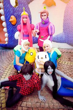 several people in costumes posing for a photo