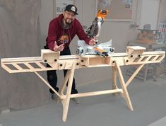 a man is working on a table made out of wood