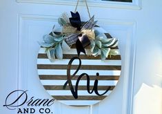 a door hanger with a monogrammed wreath on it