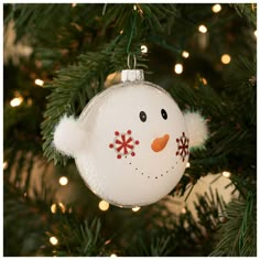 a snowman ornament hanging from a christmas tree