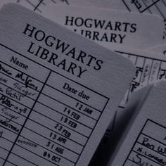 two harry potter library id cards sitting on top of each other