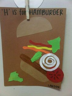 a paper cut out of a hamburger hanging on a wall