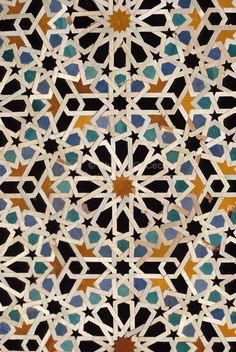 an intricate tile design with blue and orange colors on it's surface, in the middle