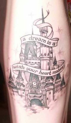 a woman's leg with a castle tattoo on it