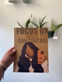 a person holding up a poster with the words focus on what you can control in front of them