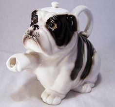 a black and white ceramic dog figurine on a white background